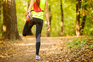 Image showing Detail of woman stretching legs 