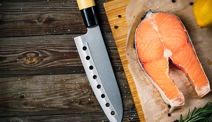 Image showing Fresh and raw steak salmon on wooden cutting