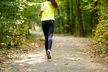 Image showing Runner feet running on road