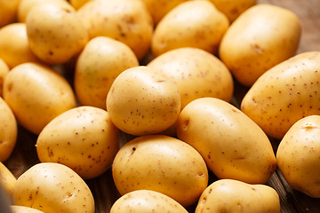 Image showing potatoes on wooden background
