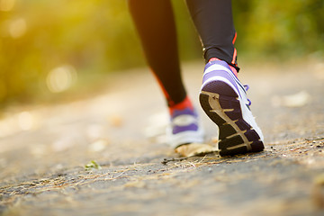 Image showing Runner feet running on road