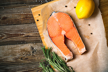 Image showing fresh salmon fillet with herbs, spices and lemon