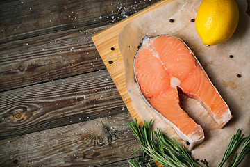 Image showing fresh salmon fillet with herbs, spices and lemon