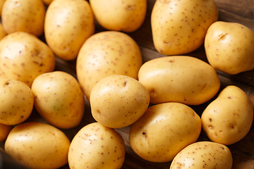 Image showing potatoes on wooden background