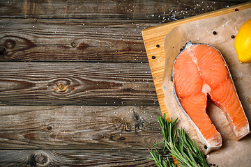 Image showing fresh salmon fillet with herbs, spices and lemon