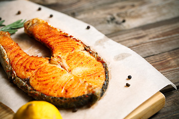 Image showing Grilled salmon on wooden table