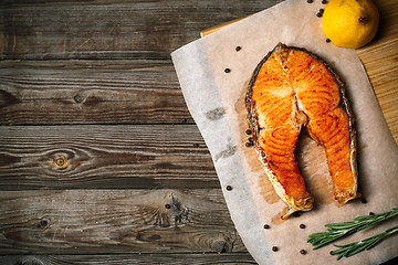 Image showing Grilled salmon on wooden table