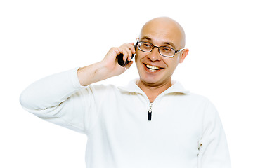 Image showing Bald smiling man speaking by phone. Studio. isolated