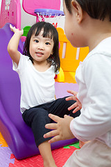 Image showing Asian Chinese little sister and brother playing on the slide
