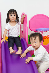 Image showing Asian Chinese little sister and brother playing on the slide