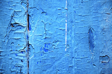 Image showing dirty stripped  in the blue wood door and rusty nail