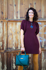 Image showing beautiful middle-aged woman in a burgundy dress