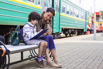 Image showing Mother and son on the railway station