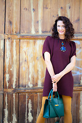 Image showing beautiful middle-aged woman in burgundy dress