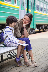 Image showing mother and son on railroad station