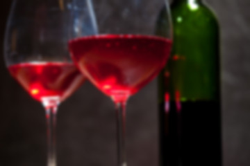 Image showing red wine in two goblets and green bottle