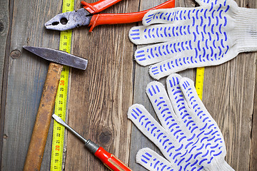 Image showing old locksmith tools, work gloves and measuring tape