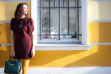 Image showing beautiful woman in a maroon dress