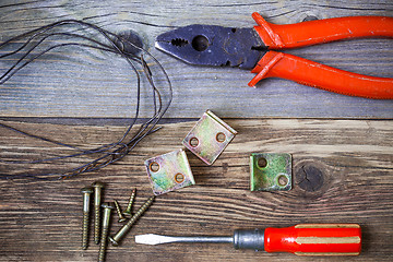 Image showing Vintage pliers old screwdriver, screws, wire and metal corners