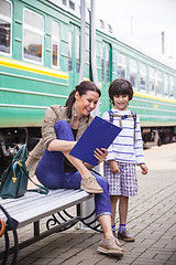 Image showing mother and son waiting for a train