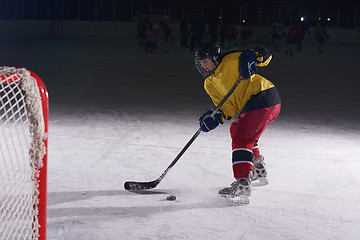 Image showing teen ice hockey player in action