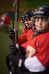 Image showing children ice hockey players on bench