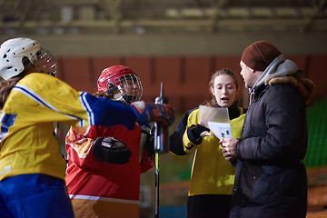 Image showing teen ice hockey players team meeting with trainer