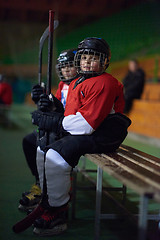 Image showing children ice hockey players on bench