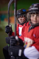 Image showing children ice hockey players on bench