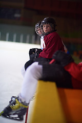 Image showing children ice hockey players on bench