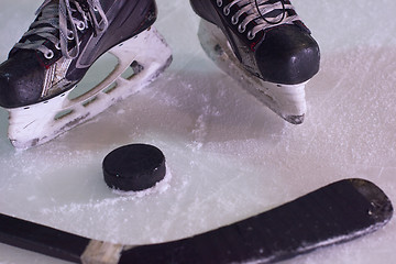 Image showing hockey sticsk and puck on ice