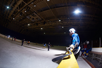 Image showing ice hockey players on bench