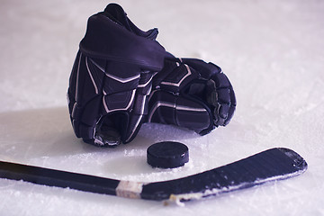 Image showing hockey sticsk and puck on ice