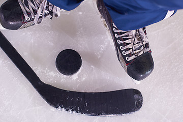 Image showing hockey sticsk and puck on ice