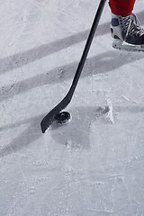 Image showing hockey sticsk and puck on ice