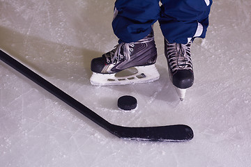 Image showing hockey sticsk and puck on ice