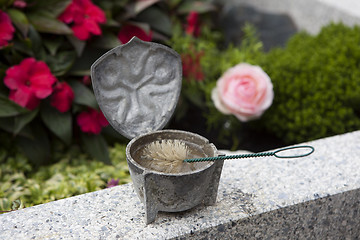 Image showing Holy water shell at the grave