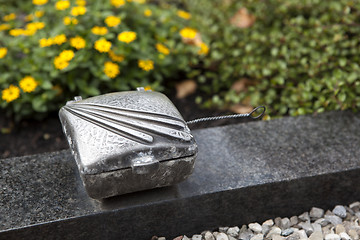 Image showing Holy water shell at the grave