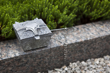 Image showing Holy water shell at the grave