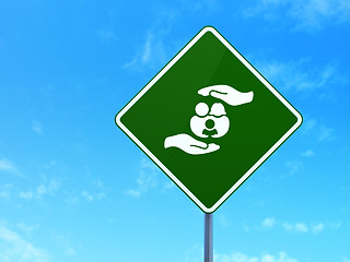 Image showing Insurance concept: Family And Palm on road sign background