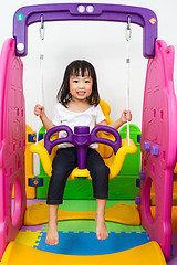 Image showing Asian Chinese little girl playing on swing