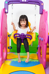 Image showing Asian Chinese little girl playing on swing