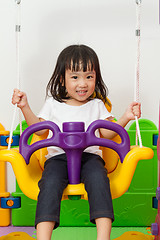 Image showing Asian Chinese little girl playing on swing