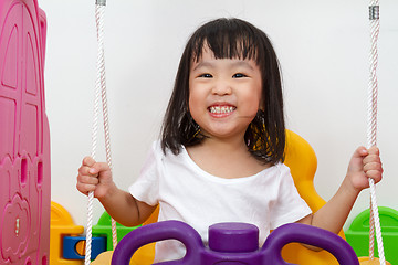 Image showing Asian Chinese little girl playing on swing