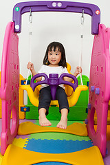 Image showing Asian Chinese little girl playing on swing