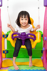 Image showing Asian Chinese little girl playing on swing