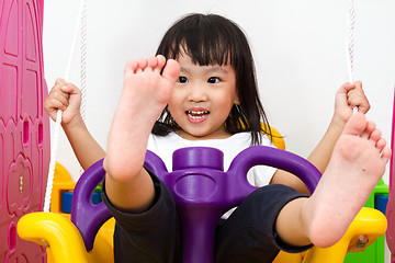 Image showing Asian Chinese little girl playing on swing