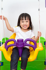 Image showing Asian Chinese little girl playing on swing