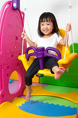 Image showing Asian Chinese little girl playing on swing