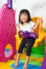 Image showing Asian Chinese little girl playing on swing